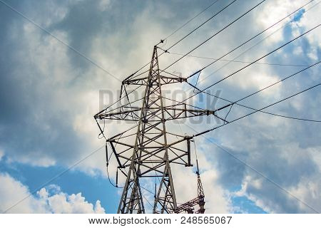 High-voltage Wires On Poles Under High Voltage. Tinted Image. Power Plants On The Industry.