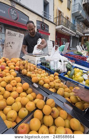 Briancon, France, 10 June 2018: Man Sells Fruit On Open Air Market Of Briancon In The French Haute P