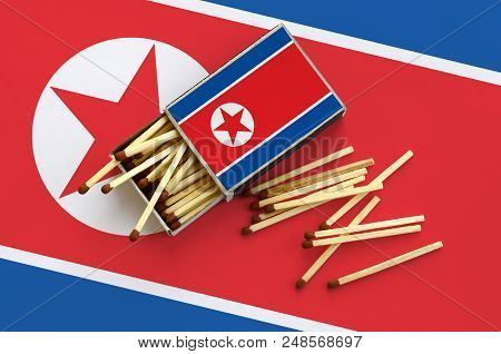 North Korea Flag  Is Shown On An Open Matchbox, From Which Several Matches Fall And Lies On A Large 