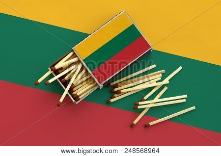 Lithuania Flag  Is Shown On An Open Matchbox, From Which Several Matches Fall And Lies On A Large Fl
