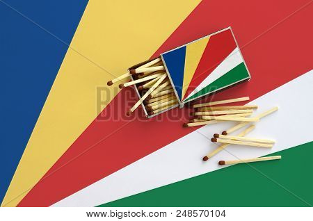 Seychelles Flag  Is Shown On An Open Matchbox, From Which Several Matches Fall And Lies On A Large F