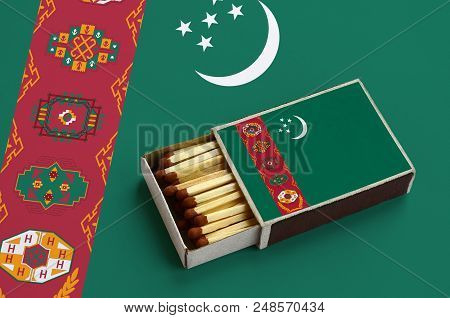 Turkmenistan Flag  Is Shown In An Open Matchbox, Which Is Filled With Matches And Lies On A Large Fl