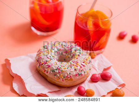 Sprinkled Pink Donut. Frosted Sprinkled Donut On Pink Background.