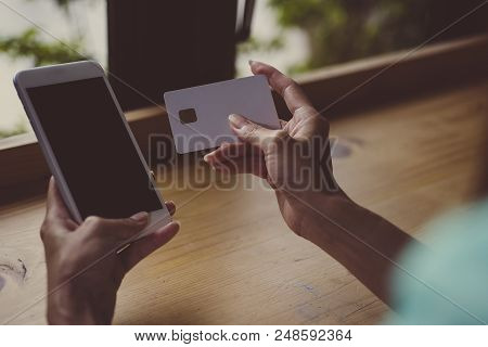 Closeup The Hand Of Businessman Is Holding Hand Credit Card And Hand Of Businesswoman Reading Text M
