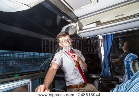Marmaris, Turkey - May 19, 2018: Male Tour Guide With A Microphone In The Bus In Evening Time