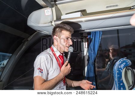 Marmaris, Turkey - May 19, 2018: Male Tour Guide With A Microphone In The Bus In Evening Time