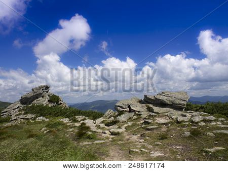 Photo Of Mountain Landscape In The Summer Under Beautiful Cloudy Sky. Ukraine, Carpathians, Dzembron