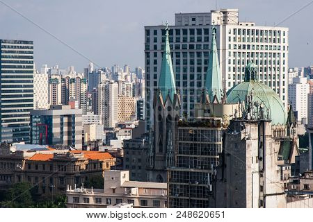Se Is The Main Cathedral Of San Paolo Metropolis In Brazil. In The Background We Can See The Skyline