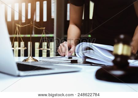 Lawsuits And Laws Concept, Male Lawyer Working With Contract Papers With Using Using Computer Laptop