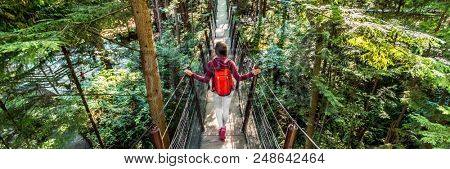 Canada travel people lifestyle banner. Tourist woman walking in famous attraction Capilano Suspension Bridge in North Vancouver, British Columbia, canadian vacation destination for tourism.