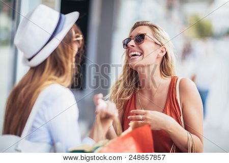 Two Happy Women With Shopping Bags Enjoying In Shopping, Haning Fun In The City.