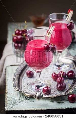 Healthy Cherry Smoothie With Frozen Strawberry, Coconat Water And Honey In Glass On White Wooden Tab