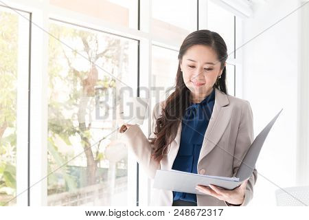 Close Up Beauty Asian Business Woman Hoding A Cup Of Coffee Near Window For Relaxation Time And Happ