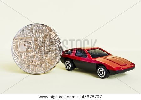 Close-up View Of Bitcoin And Red Car.