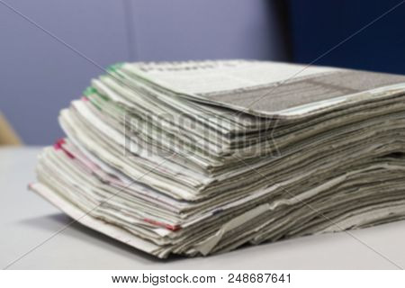 Blurred - Newspaper Stack On White Table In Work Office