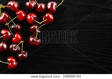 Sweet Bright Red Cherry Left Upper Corner Flatlay On Black Wood