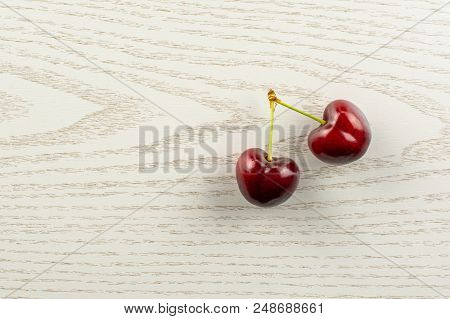 Group Of Two Whole Sweet Bright Red Cherry Flatlay On Grey Wood
