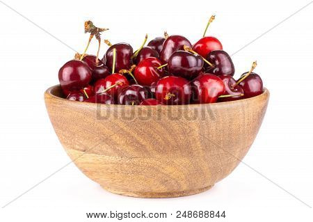 Sweet Bright Red Cherry In A Wooden Bowl Isolated On White
