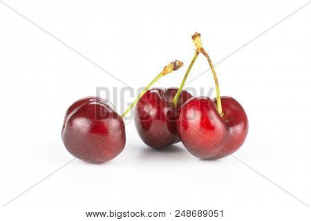 Group Of Three Whole Sweet Bright Red Cherry Isolated On White