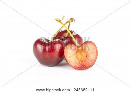 Group Of Two Whole One Half Of Sweet Bright Red Cherry Isolated On White