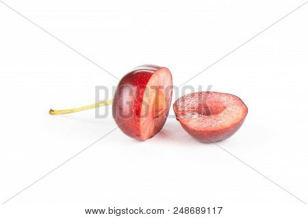 Group Of Two Halves Of Sweet Bright Red Cherry One Cut In Halves Isolated On White