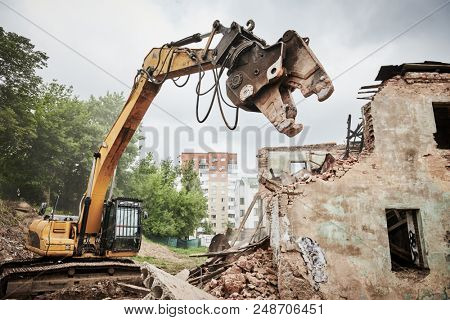 excavator crasher machine at demolition on construction site