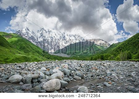 Landscape Of Svaneti Mountains, Georgia. Amazing View Of Mountain Dzhangi-tau And Glacier Khalde Fro