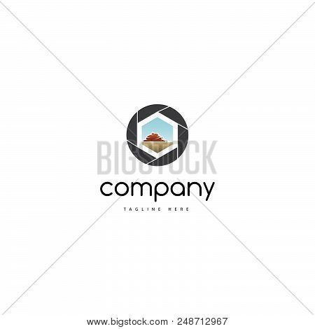 On The Logo Is An Abstract Image Of The Camera Shutter In The Center Of Which Is A Landscape With Mo
