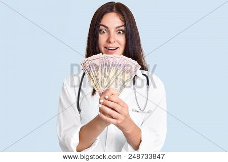 Surprised Female Doctor Has Her Own Clinic, Looks At Cash With Shocked Expression, Can`t Beleive Her