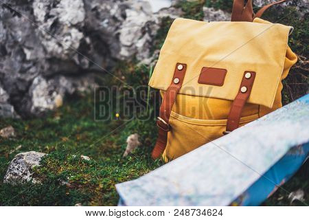 Hipster Hiker Tourist Yellow Backpack And Map Europe On Background Green Grass Nature In Mountain, B