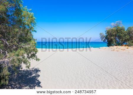 Tropical Beach With Tamarisk And Turquoise Water In Komos, Crete, Greece