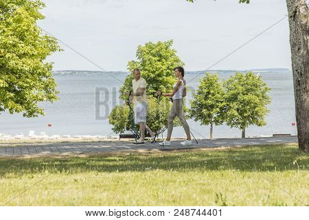 Young Couple Hiking In The Nature Nordic Walking