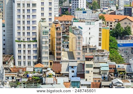 Ho Chi Minh City, Vietnam - 4 April, 2018: A Few Remaining Typical Narrow Old Buildings In A Fast Gr