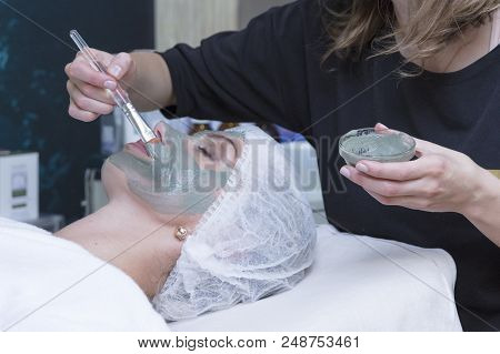 Young Beautiful Girl Receiving Pink Mask In Spa Beauty Salon - Indoors