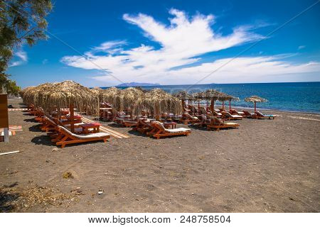 Permissa black sand beach in Santorini. Greece. 