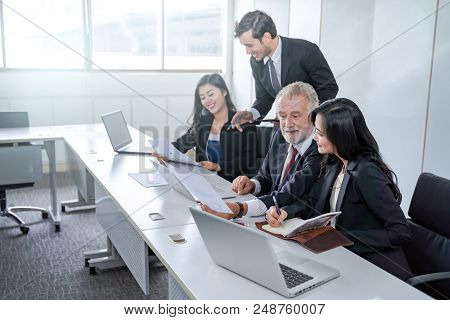 group of successful businessman. Discussion of the business profits of the company in meeting roon o