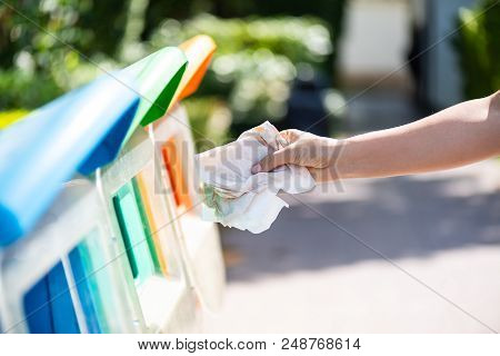 World Environment Day, June 5. Woman Hand Holding And Putting Issue Paper Waste Into Garbage Trash.