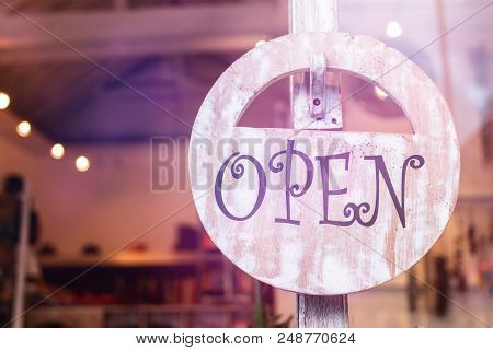 Open Sign Broad Through The Glass Of Window At The Shop. Bali Island.