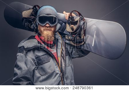 Portrait Of A Snowboarder Dressed In A Full Protective Gear For Extream Snowboarding Posing With A S