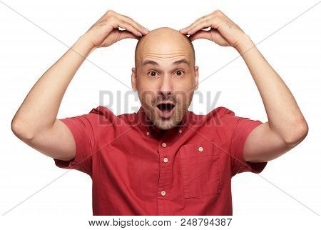 Shocked Bald Man Holds His Head. Isolated