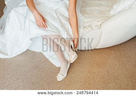 Beautiful Woman Legs In Whitel Shoes. Wedding Dress And Shoes. Morning Of The Bride.