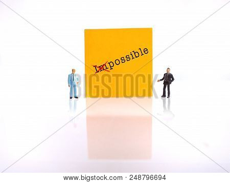 Photo Two Mini Figure Businessman Explaining Change Impossible Into Possible Thing