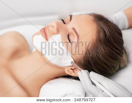 Closeup Of A Beauty Therapist Applying A Face Mask To A Woman With Perfect Freshh Skin. Cosmetology 