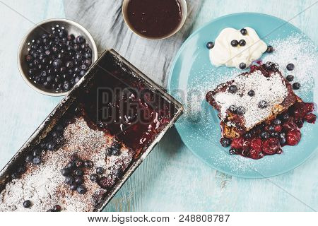 Top View Of Berry Crumble In The Baking-tin, Small Bowl With Blueberries And Plate With Pie On The B