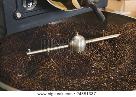 The Freshly Roasted Coffee Beans From A Large Coffee Roaster In The Cooling Cylinder. Motion Blur On