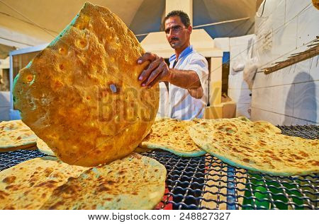 Kerman, Iran - October 15, 2017: 
The Bakers At Work - The Small Bakery Offers Hot, Fresh And Tasty 