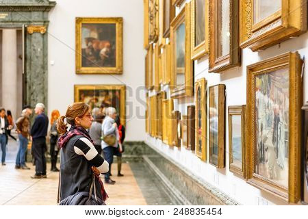 London, Uk - August 15, 2017 - A Female Visitor Admiring Paintings Displayed At Tate Britain