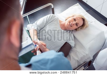 Doctor greeting patient before starting treatment in hospital