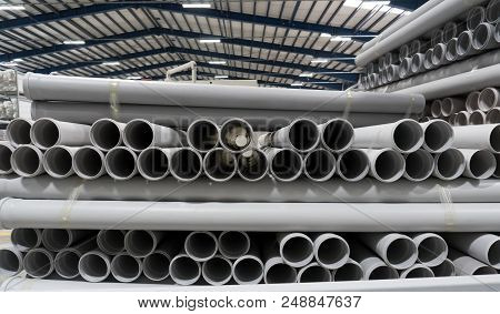 Stack Of Pvc Pipes Inside A Factory. Front View.