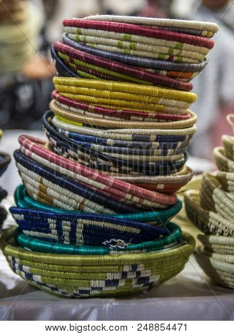 Close up of many hand- woven or handcrafted baskets stocked in a shop. Product from cottage industry.